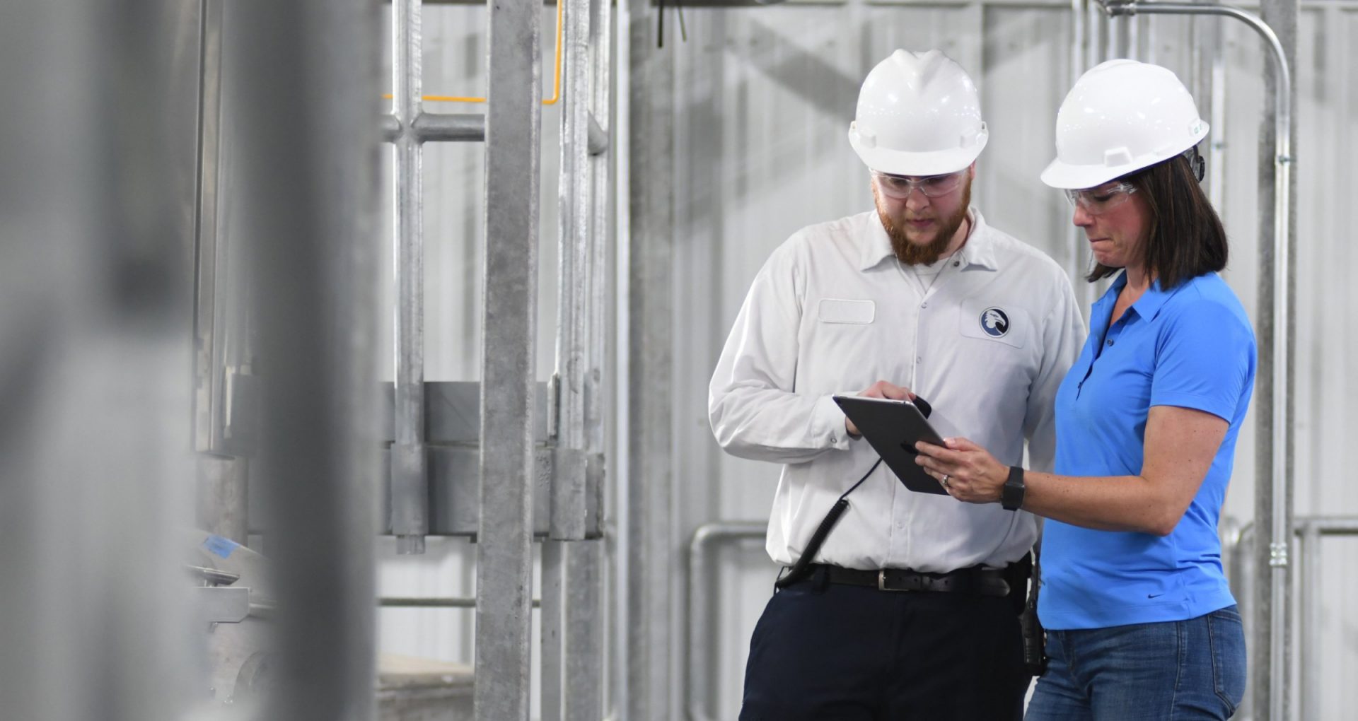 A Bundy service rep and customer discuss plans while looking at a tablet